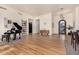 Bright entryway with hardwood floors, piano, and decorative shelving at 8951 E Wethersfield Rd, Scottsdale, AZ 85260