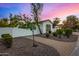 Landscaped walkway leads to a charming home with stone accents and a white gate at 8951 E Wethersfield Rd, Scottsdale, AZ 85260