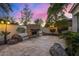 Inviting firepit area with stone fireplace and seating at 8951 E Wethersfield Rd, Scottsdale, AZ 85260