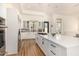 Open concept kitchen with white cabinets and a large island at 8951 E Wethersfield Rd, Scottsdale, AZ 85260