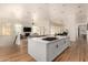 Modern kitchen with white cabinets, island, and open floor plan at 8951 E Wethersfield Rd, Scottsdale, AZ 85260