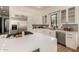 Contemporary kitchen featuring white cabinets and a breakfast bar at 8951 E Wethersfield Rd, Scottsdale, AZ 85260