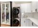 Modern laundry room with stackable washer and dryer at 8951 E Wethersfield Rd, Scottsdale, AZ 85260