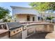 Outdoor kitchen featuring stainless steel appliances and granite countertops at 8951 E Wethersfield Rd, Scottsdale, AZ 85260