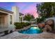 Serene pool area with waterfall, flagstone, and lush landscaping at 8951 E Wethersfield Rd, Scottsdale, AZ 85260