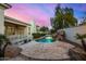 Relaxing pool area with waterfall feature and flagstone decking at 8951 E Wethersfield Rd, Scottsdale, AZ 85260