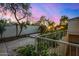 Landscaped pool area with stone patio and waterfall at 8951 E Wethersfield Rd, Scottsdale, AZ 85260