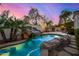 Relaxing pool and spa with waterfall feature and flagstone decking at 8951 E Wethersfield Rd, Scottsdale, AZ 85260