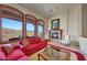 Bright living room with large windows, fireplace and red couch at 9624 N Copper Ridge Trl, Fountain Hills, AZ 85268