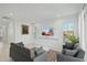 Spacious living room with gray sofas, large windows, and tasteful decor at 9835 E Stratus Ave, Mesa, AZ 85212