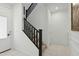 Modern staircase with dark wood railing and white walls at 9835 E Stratus Ave, Mesa, AZ 85212