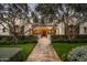 Stunning home with arched entryway, lush landscaping, and stone pathway at 10320 E Mountain Spring Rd, Scottsdale, AZ 85255