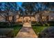 Elegant home with a stucco exterior, arched entryway, and manicured landscaping at 10320 E Mountain Spring Rd, Scottsdale, AZ 85255