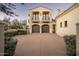 Two-car garage with carriage-style doors and second story balcony at 10320 E Mountain Spring Rd, Scottsdale, AZ 85255