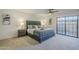 Spacious bedroom with a plush bed, ceiling fan, and sliding glass door at 10410 N Cave Creek Rd # 1220, Phoenix, AZ 85020