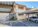 Exterior view of condo building with parking and stairs at 10410 N Cave Creek Rd # 1220, Phoenix, AZ 85020