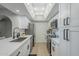 Modern white kitchen with stainless steel appliances and quartz countertops at 10410 N Cave Creek Rd # 1220, Phoenix, AZ 85020