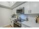 Modern kitchen with stainless steel appliances and white shaker cabinets at 10410 N Cave Creek Rd # 1220, Phoenix, AZ 85020