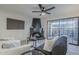 Living room with fireplace, sliding glass door, and ceiling fan at 10410 N Cave Creek Rd # 1220, Phoenix, AZ 85020