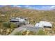 Aerial view of a contemporary home with a long driveway and desert landscape at 11541 E Salero Dr, Scottsdale, AZ 85262