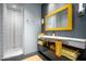 Modern bathroom with white tile, a floating vanity, and yellow towels at 11541 E Salero Dr, Scottsdale, AZ 85262