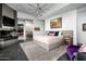 Main bedroom with a king-size bed, fireplace, and sliding barn door at 11541 E Salero Dr, Scottsdale, AZ 85262