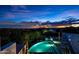 Night view of a luxury pool and city lights at 11541 E Salero Dr, Scottsdale, AZ 85262