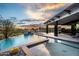 Luxury pool and spa with mountain views at sunset at 11541 E Salero Dr, Scottsdale, AZ 85262