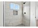 Bathroom with tile shower and built-in niche at 12360 W Delwood Dr, Arizona City, AZ 85123