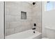 Bathroom with gray tile and a bathtub at 12360 W Delwood Dr, Arizona City, AZ 85123