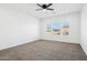 Well-lit bedroom with ceiling fan and carpet at 12360 W Delwood Dr, Arizona City, AZ 85123