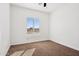 Bedroom with carpeted floor and large window at 12360 W Delwood Dr, Arizona City, AZ 85123