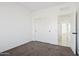 Spacious bedroom with carpet and double sliding doors to closet at 12360 W Delwood Dr, Arizona City, AZ 85123