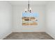 Simple dining area with wood-look floors and a window with blinds at 12360 W Delwood Dr, Arizona City, AZ 85123