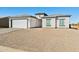 Newly built house with a two-car garage, light-colored exterior, and gravel driveway at 12360 W Delwood Dr, Arizona City, AZ 85123