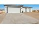 Modern house with a two-car garage and a large concrete driveway at 12360 W Delwood Dr, Arizona City, AZ 85123