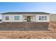 House exterior back view, showing patio and yard at 12360 W Delwood Dr, Arizona City, AZ 85123