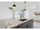 Modern kitchen island with granite countertop and black sink at 12360 W Delwood Dr, Arizona City, AZ 85123