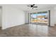 Bright living room with wood-look floors and sliding glass doors to backyard at 12360 W Delwood Dr, Arizona City, AZ 85123