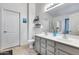 Double vanity bathroom with gray cabinets and a large mirror at 12409 W Montebello Ave, Litchfield Park, AZ 85340