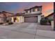 Two-story house with a two-car garage and landscaped front yard at 12409 W Montebello Ave, Litchfield Park, AZ 85340