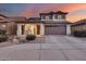 Two-story house with a two-car garage and landscaped front yard at 12409 W Montebello Ave, Litchfield Park, AZ 85340