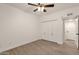 Bright bedroom with wood-look floors, ceiling fan and built-in closet at 1245 W 1St St # 103, Tempe, AZ 85281