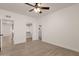 Spacious bedroom with wood-look floors, ceiling fan, and ample closet space at 1245 W 1St St # 103, Tempe, AZ 85281