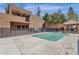 Community pool with surrounding patio and building view at 1245 W 1St St # 103, Tempe, AZ 85281