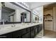 Double vanity bathroom with dark cabinets and a walk-in closet at 13842 S 40Th St # 1004, Phoenix, AZ 85044