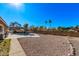 Spacious backyard with gravel landscaping and a refreshing pool at 1518 N 62Nd Pl, Mesa, AZ 85205