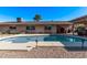 Relaxing kidney-shaped pool, patio, and covered seating area at 1518 N 62Nd Pl, Mesa, AZ 85205