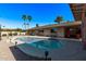 Inviting kidney-shaped pool with patio and covered seating area at 1518 N 62Nd Pl, Mesa, AZ 85205