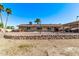 Landscaped backyard with a rock wall and a refreshing pool at 1518 N 62Nd Pl, Mesa, AZ 85205